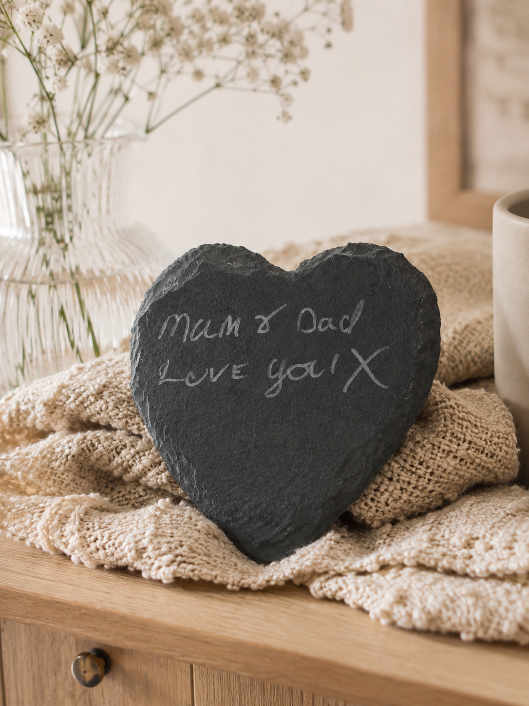 Heart-shaped slate with 'Mum & Dad Love you X' on a textured surface