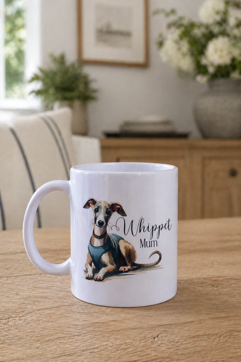 White mug with a dog illustration and 'Whippet Mutt' text on a wooden table.