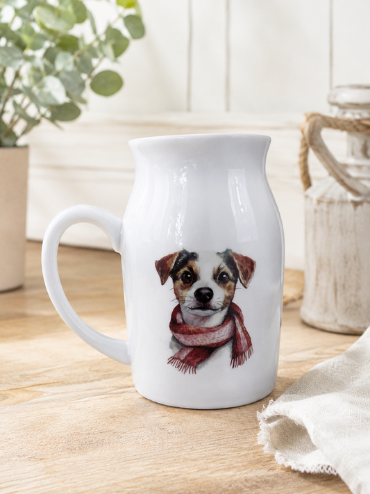 White mug with a dog wearing a scarf design on a wooden surface.