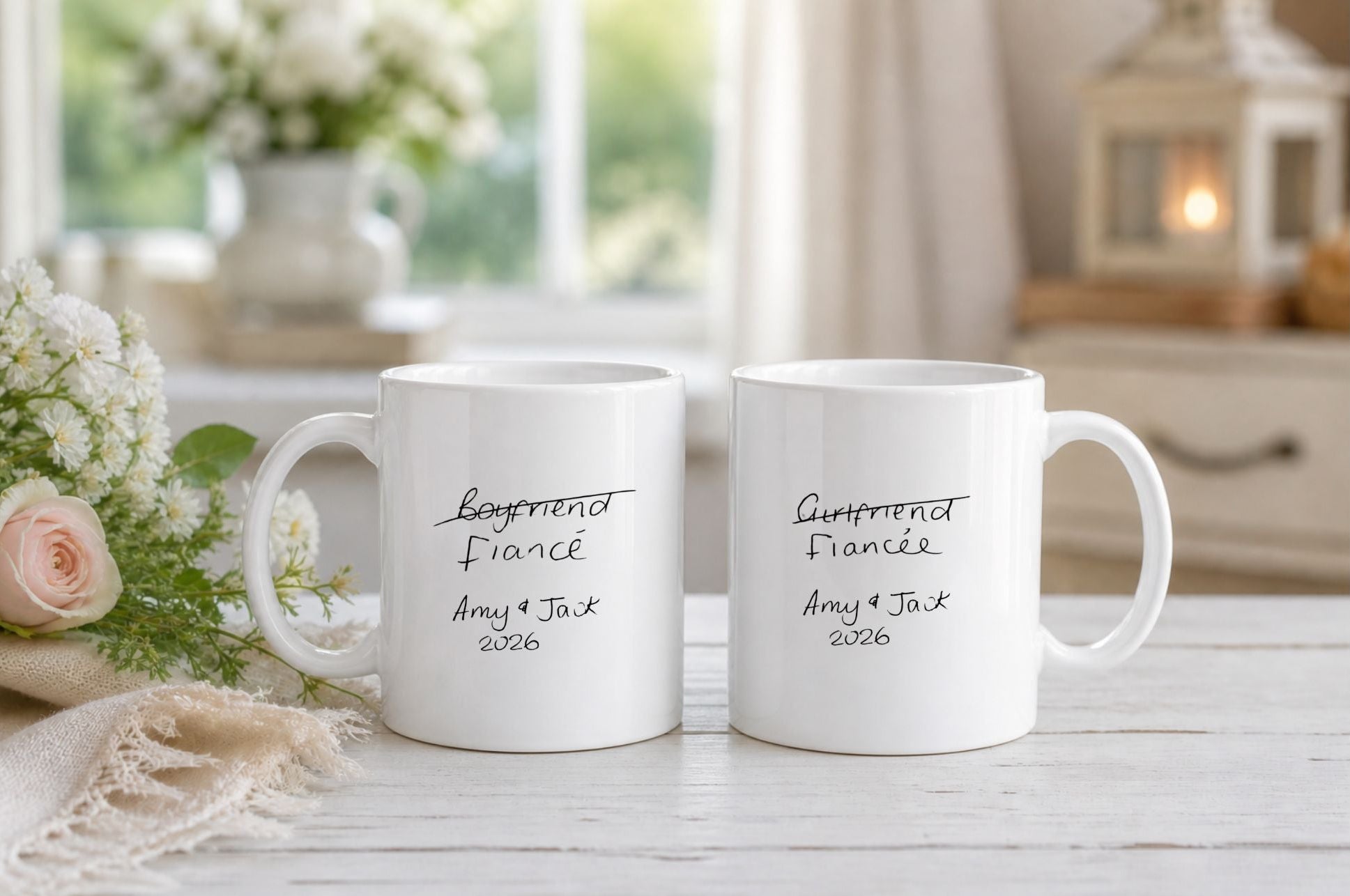 Two white mugs with Handwritten text on a table with flowers and decor in the background