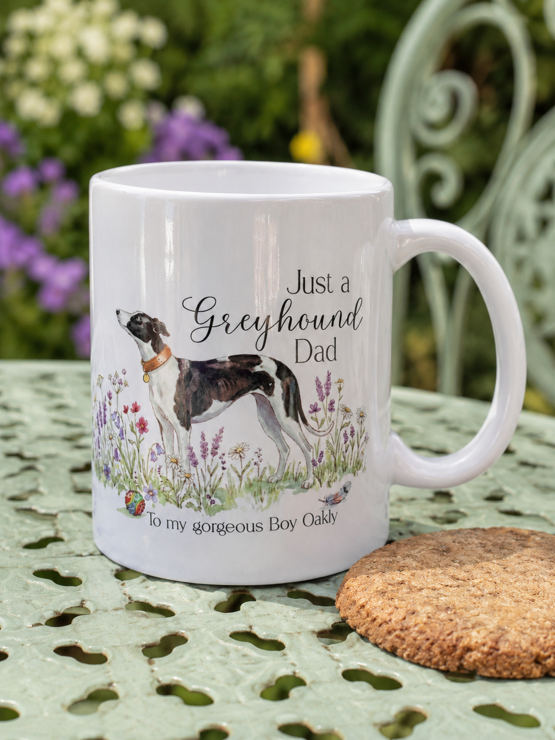 White mug with a dog illustration and text on a garden table
