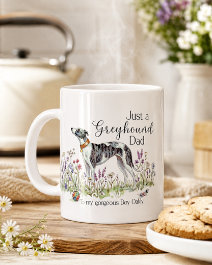 White mug with a dog illustration and text on a wooden table with flowers and cookies.